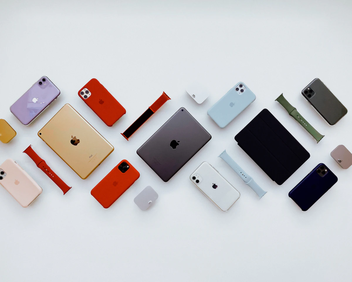 A flat lay of iPhones, an iPad and accessories